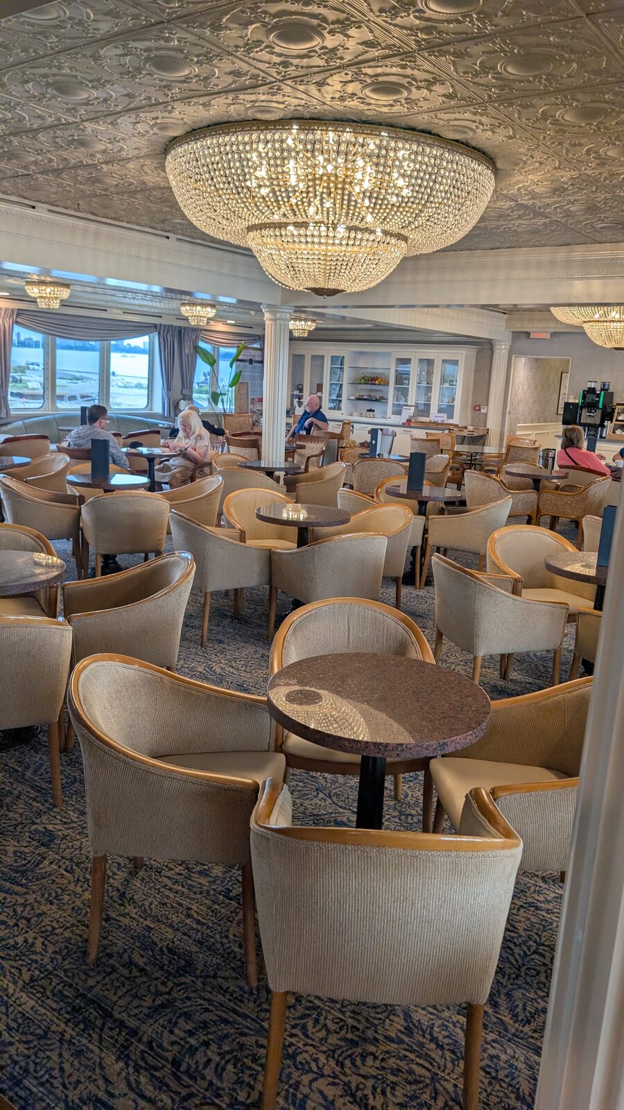 The Compass Lounge on Victory II with crystal chandeliers and armchairs