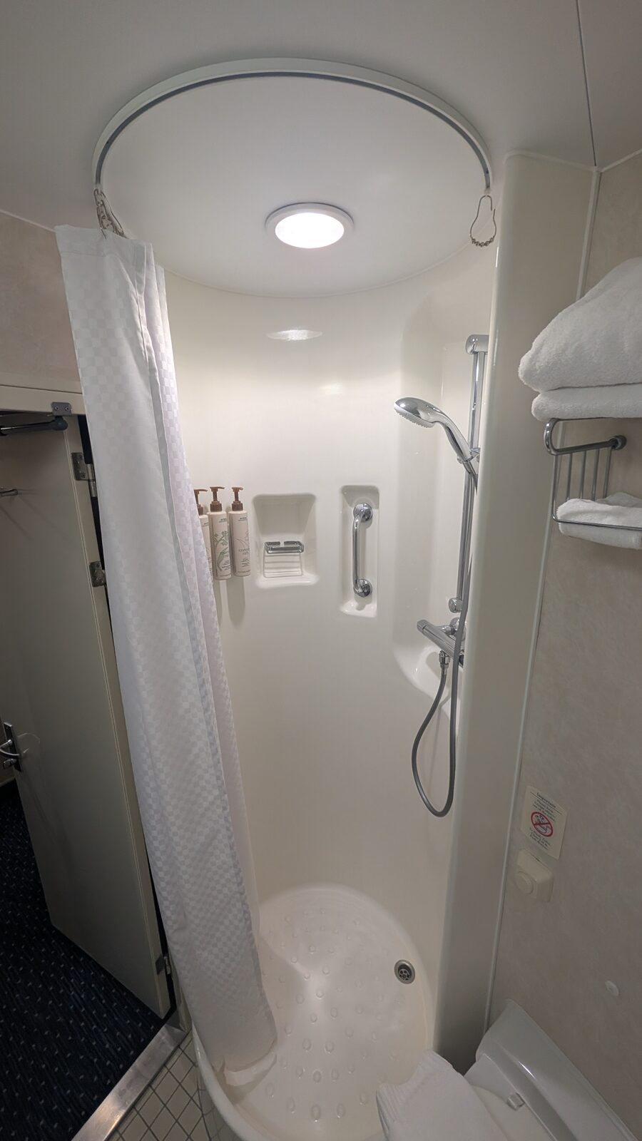 Compact round shower stall in a Victory II stateroom bathroom