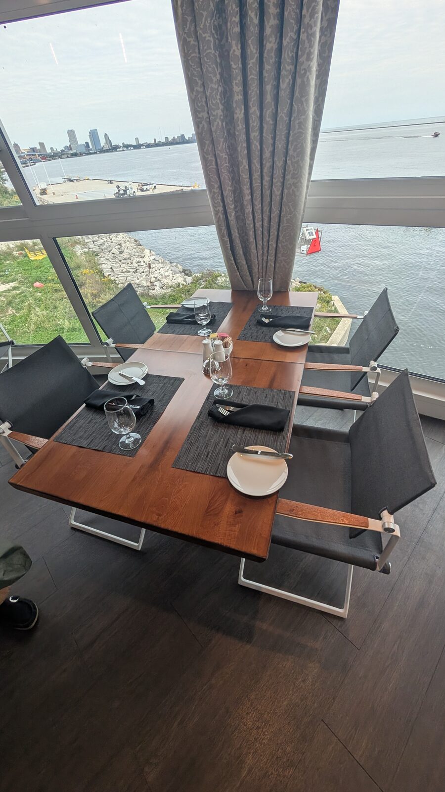 Table in The Grill on Victory II with floor-to-ceiling windows overlooking the Milwaukee skyline
