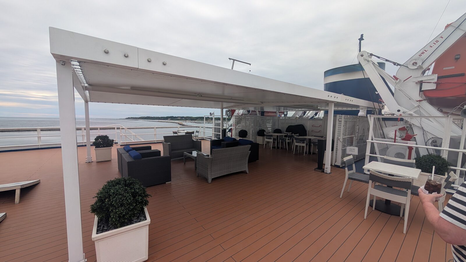 Shaded lounge area with sofas under a pergola on the Victory II sun deck