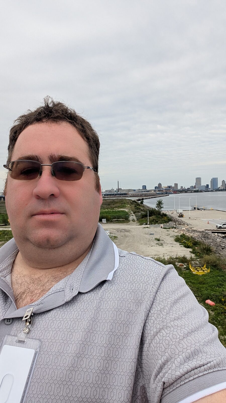 Andrew Hooker on the Victory II sun deck with the Milwaukee skyline behind him