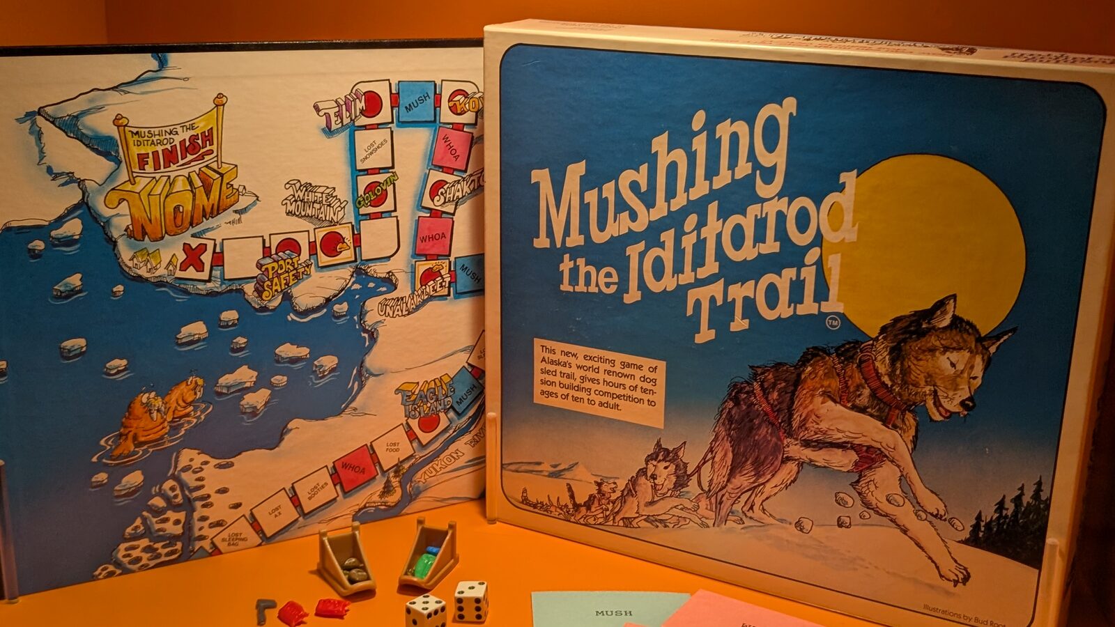 A vintage Mushing the Iditarod Trail board game on display at the Anchorage Museum, with a sled dog team on the box and a board mapping the trail to Nome